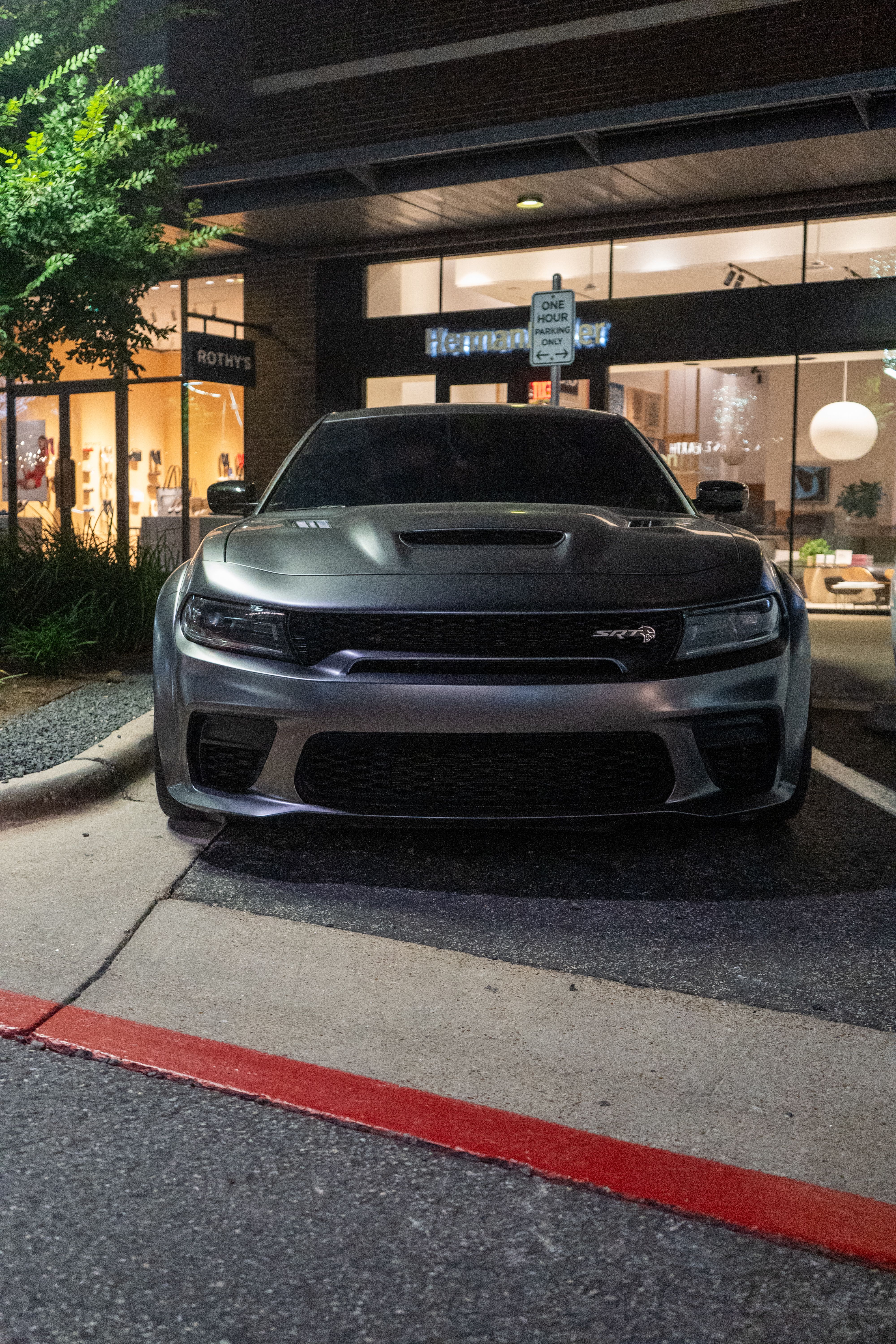 Dodge Charger SRT, downtown storefront, head-on at night