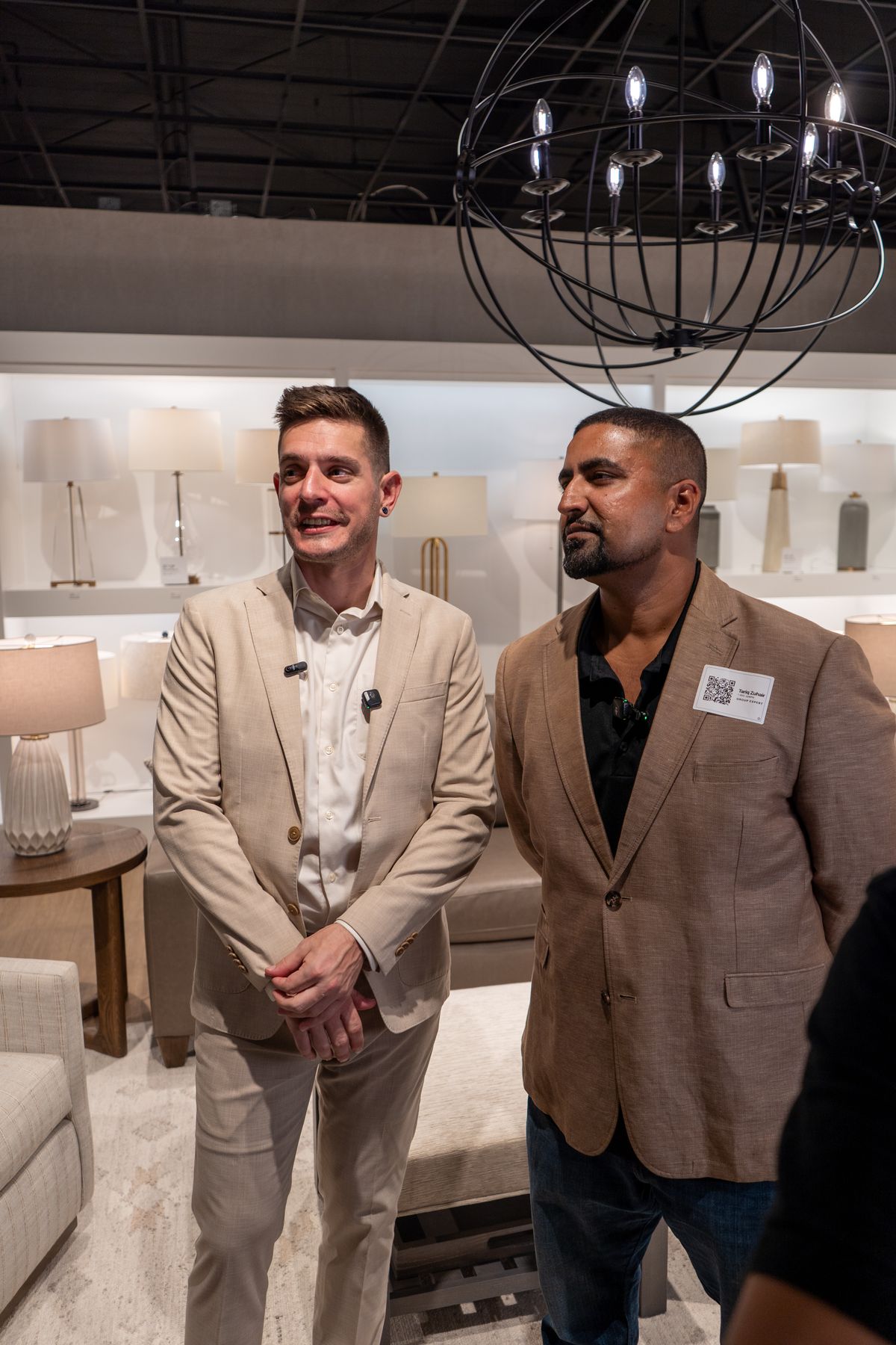 Two attendees at the furniture showroom networking mixer
